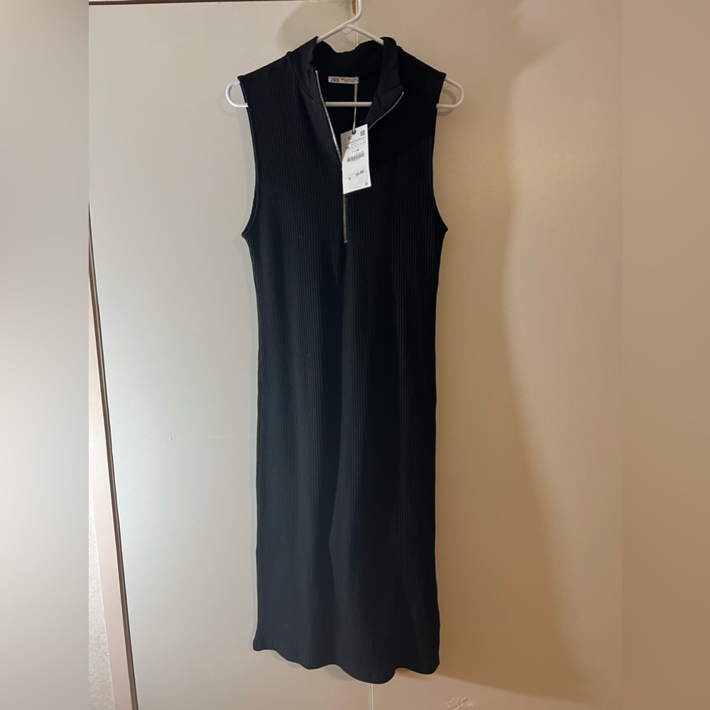 Thick material. Zipper front. Never worn dress with tags